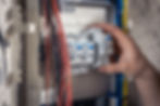 male-electrician-works-switchboard-with-electrical-connecting-cable.jpg