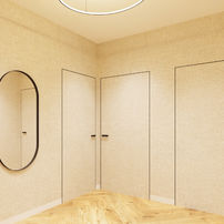 Minimalistyczny przedpokój z drzwiami ukrytymi zlicowanymi ze ścianą, owalnym lustrem i jasną podłogą drewnianą.