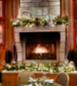 Holiday decor around a fireplace inside the Trezo Mare restaurant lounge