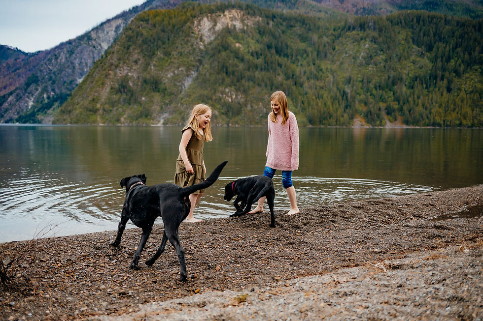 Two girls playing with their dogs for their session with Spokane Wa Family Photographer