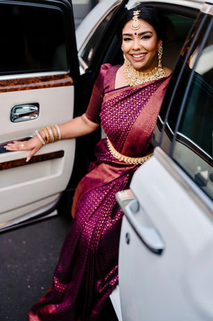 a woman in a sari getting out of a car. 