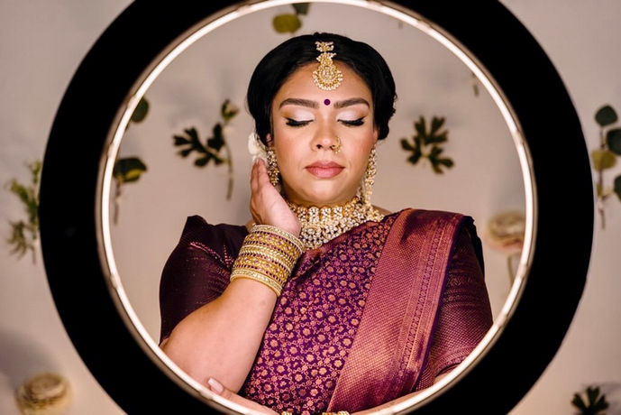 a woman in a purple sari headshot 