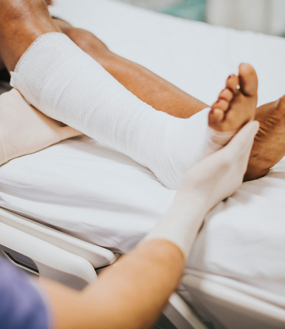 doctor-helping-patient-with-fractured-leg.jpg