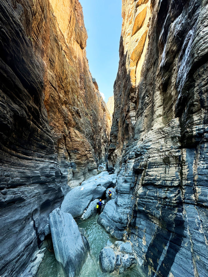 Snake Canyon canyoning adventure in Oman with waterfalls, gorges, and turquoise pools in Wadi Bani Awf.
