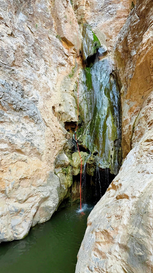 Wadi Halfeen canyoning tour in Oman with waterfall abseiling, wadi hiking, and overnight camping under the stars.