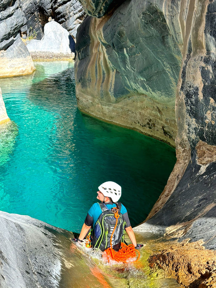 Adventure canyoning in Wadi Hatt Oman with narrow gorges, waterfalls, and natural pools on a 1-day tour.