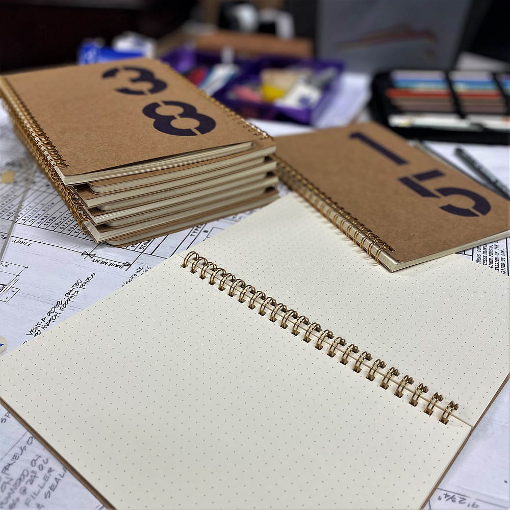 Sketchbooks with hand-stenciled numbers.