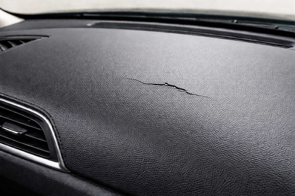 Close-up view of a leather dashboard showing cracks and wear