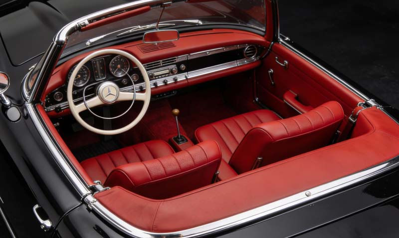 Close-up view of a car seat with cracked leather before repair