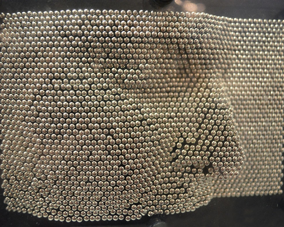a face pressed into a pin art toy