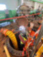 Eye-level view of a confined space entry point with safety equipment