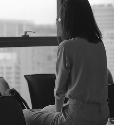 woman in white coat sitting on black cha