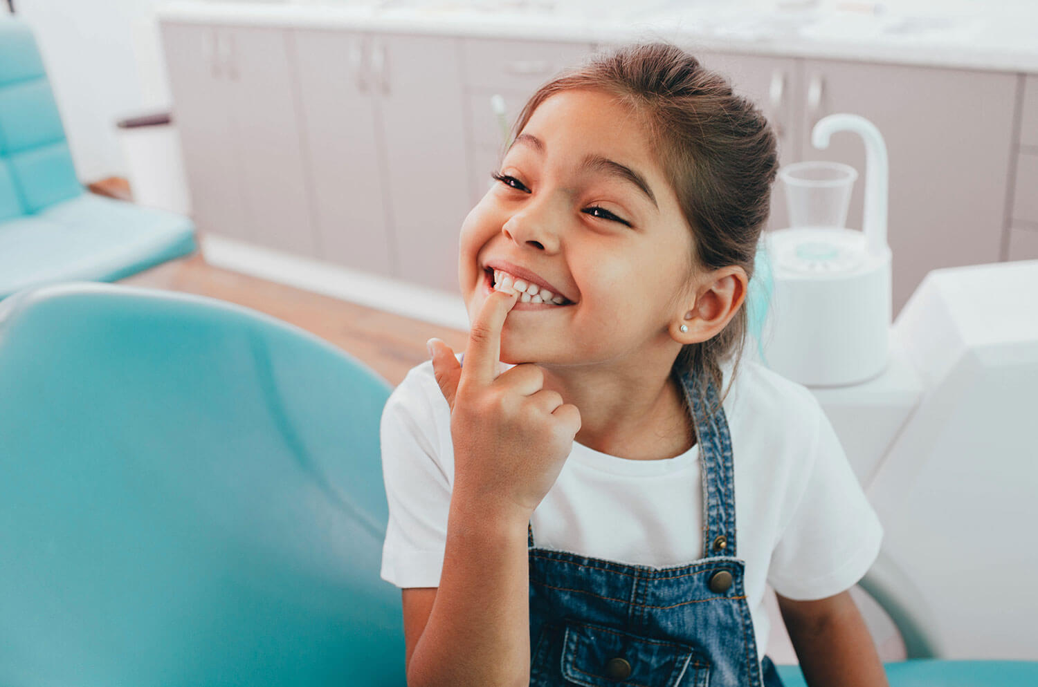 Young girl smiling and showing her beautiful teeth