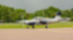Multi-engine aircraft taxiing on the runway