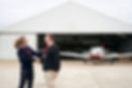 Flight instructor congratulating a student pilot