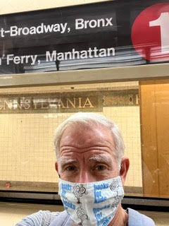 Steven Fuchs wearing a books for kids mask in an NYC subway 1 train station