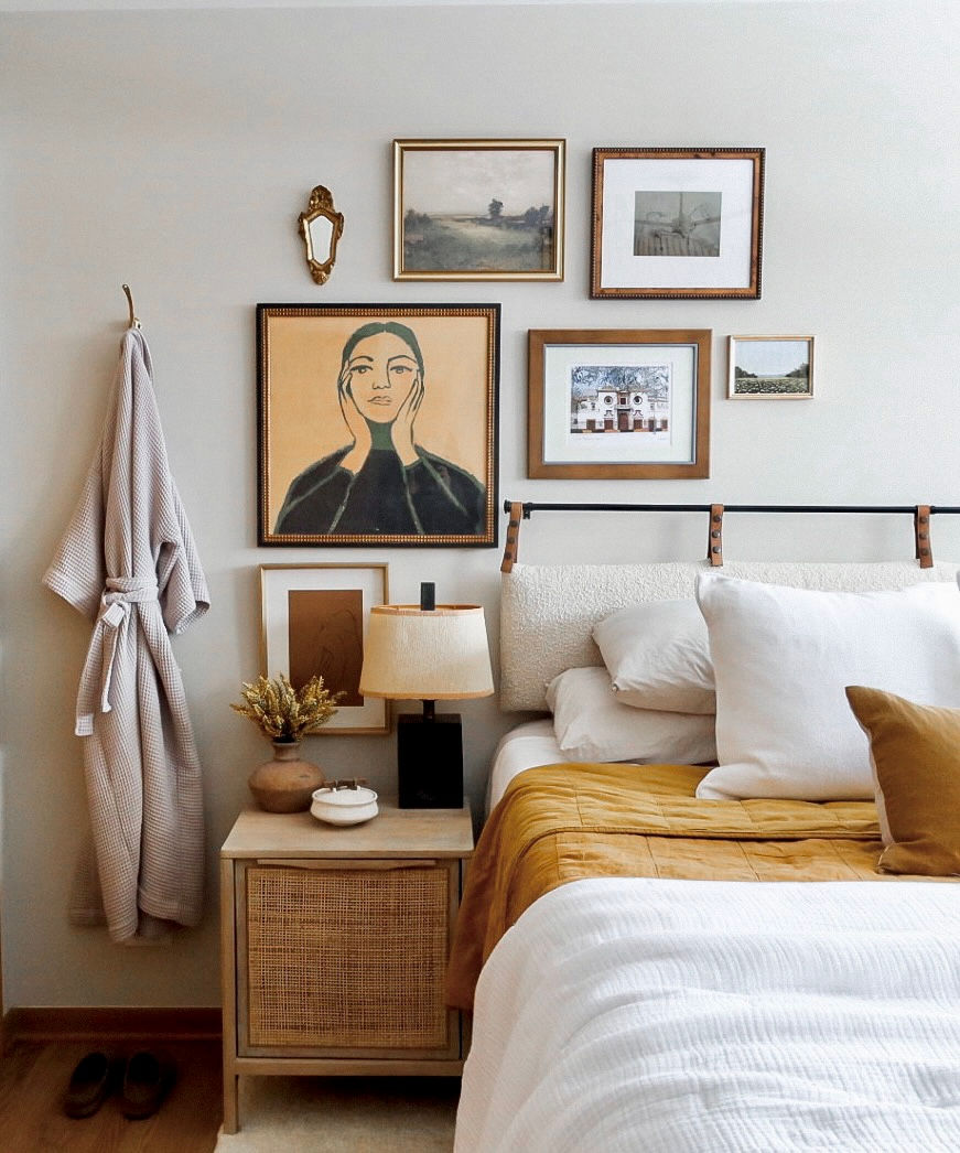 primary bedroom, modern bedroom, artistic bedroom, parachute bedding, gallery wall, art wall, robe, mid century lamp, wood headboard, boucle headboard