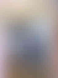 A wooden panel that says "BLVCKSCVLE" in black at the top with photos of models and clothing