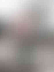 Tyrod Taylor walks on a crosswalk wearing a red and white grid jacket with jeans