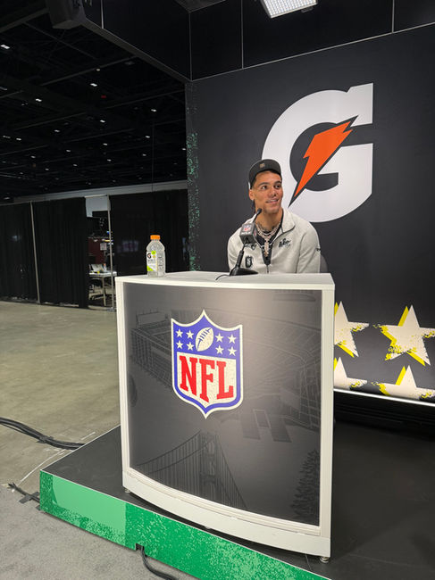 Christian Gonzalez sitting at an NFL podium