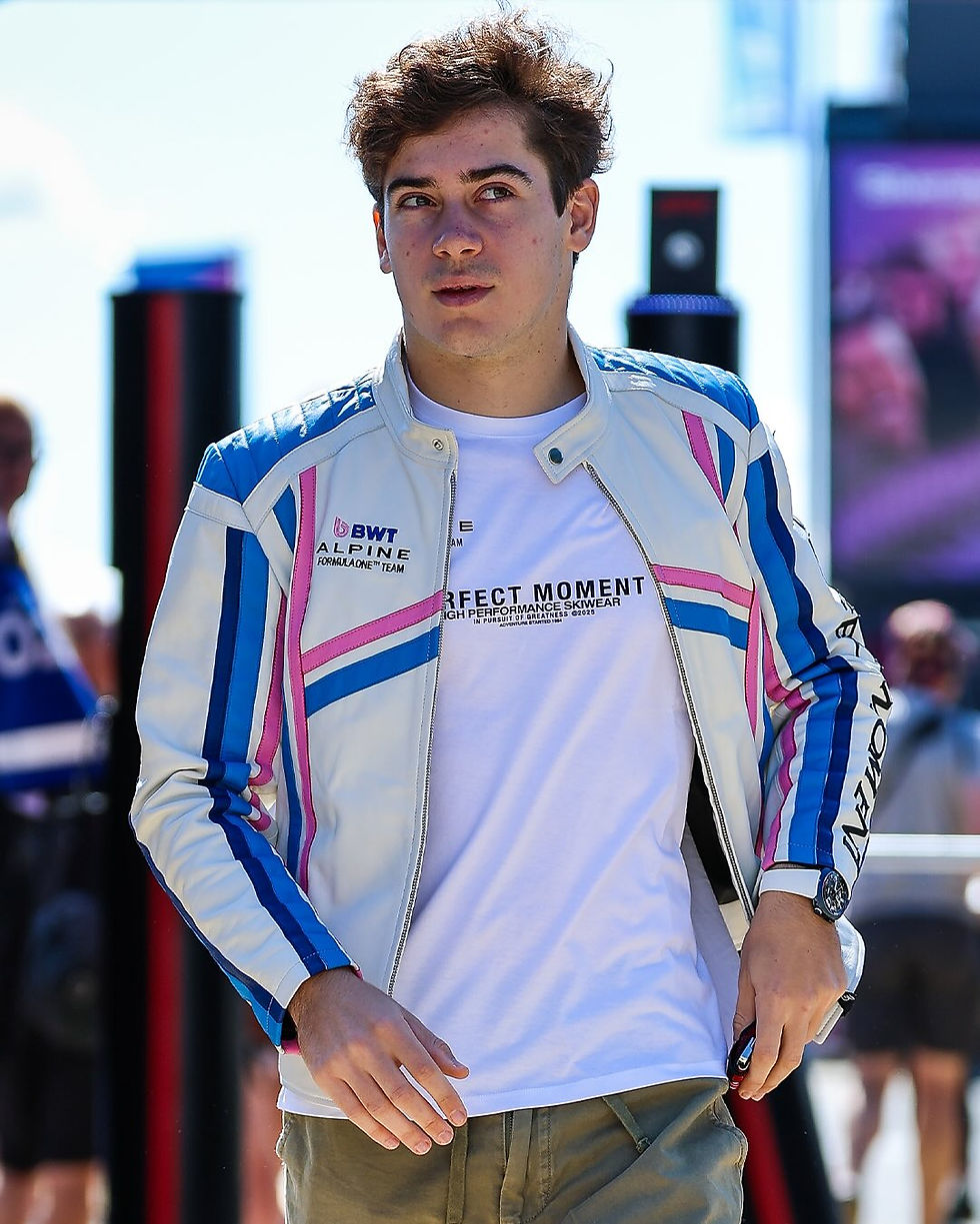 Franco Colapinto wearing a white leather jacket with pink and blue stripes from the Alpine x Perfect Moment at Silverstone