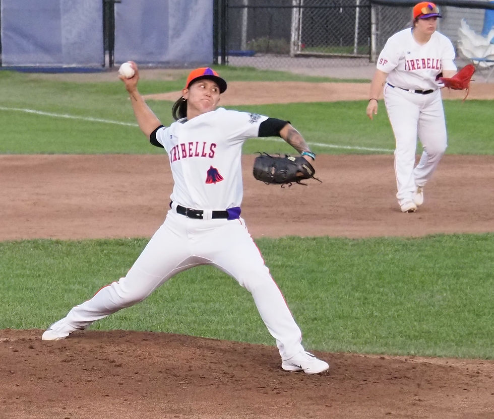 Kelsie Whitmore winds up to throw a baseball on the mound