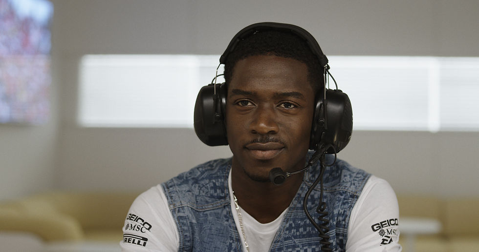 Joshua Pearce, played by Damson Idris, wears a headset in a still from "F1: The Movie"