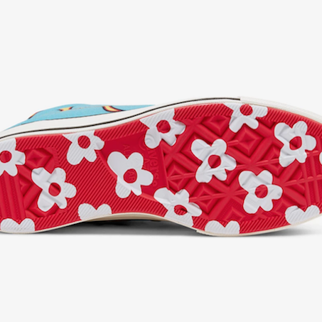 The sole of a Converse sneaker with a red base and white flowers