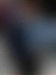 Lewis Hamilton walking in the F1 paddock wearing a navy Willy Chavarria track jacket