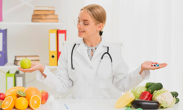 medium-shot-doctor-holding-up-apple-pills.jpg