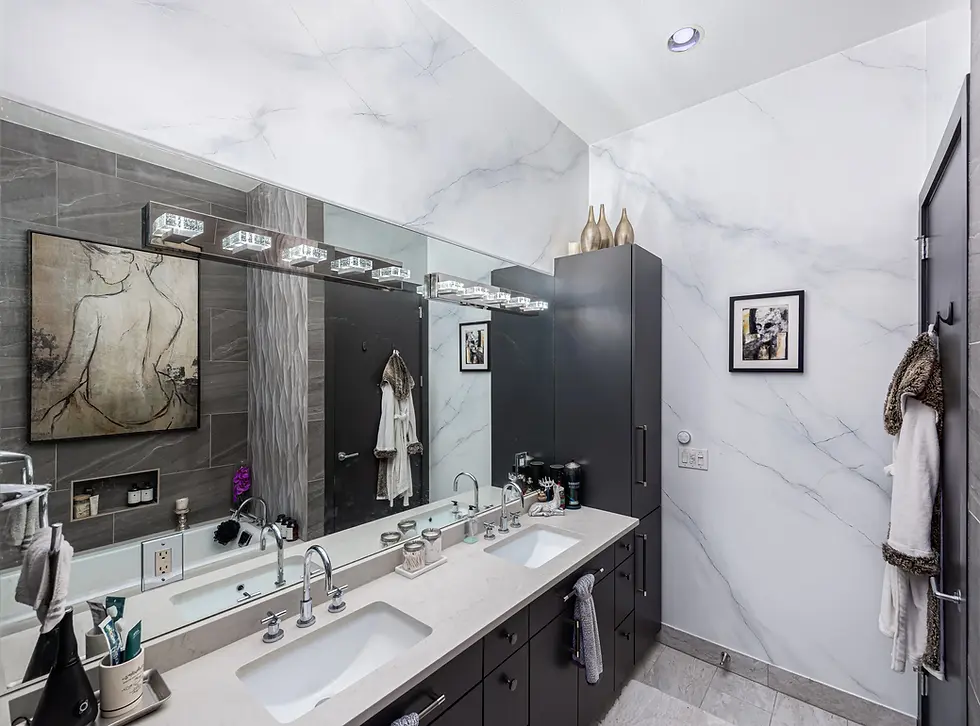 An elegant modern bathroom with level-5 finish, custom faux marble walls with mirroriest mirror veining and white sparkle ceiling.