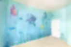 Rainbow Fish Inspired Nursery Mural painted by Artist Couple in Round Rock Texas