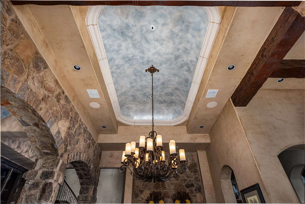 A picture of a faux marble ceiling in metallic blues, silvers and whites in a large dining room.