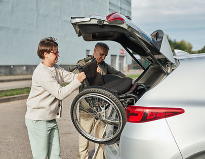 couple-unloading-wheelchair-in-parking-lot