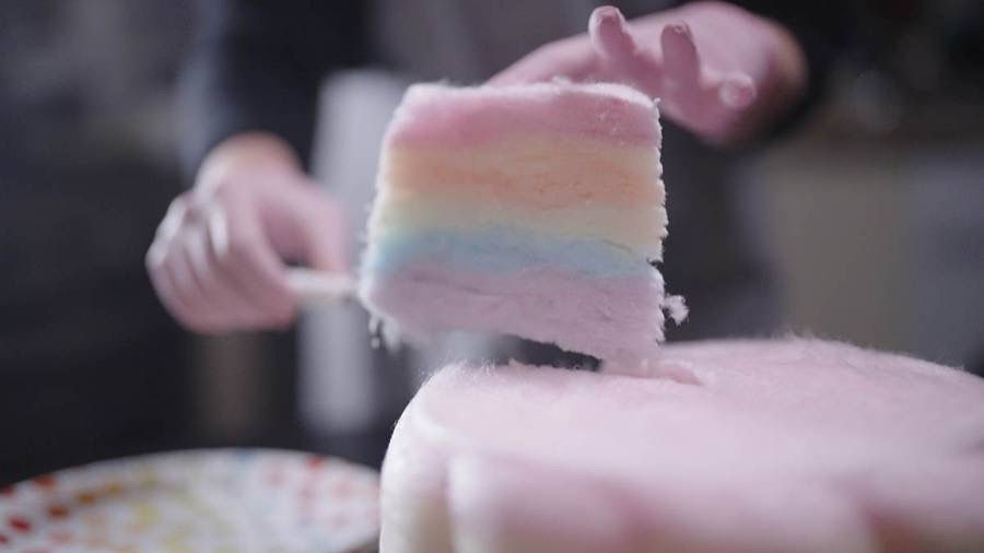 Slice of pastel Whirlylicious candy floss cake being served