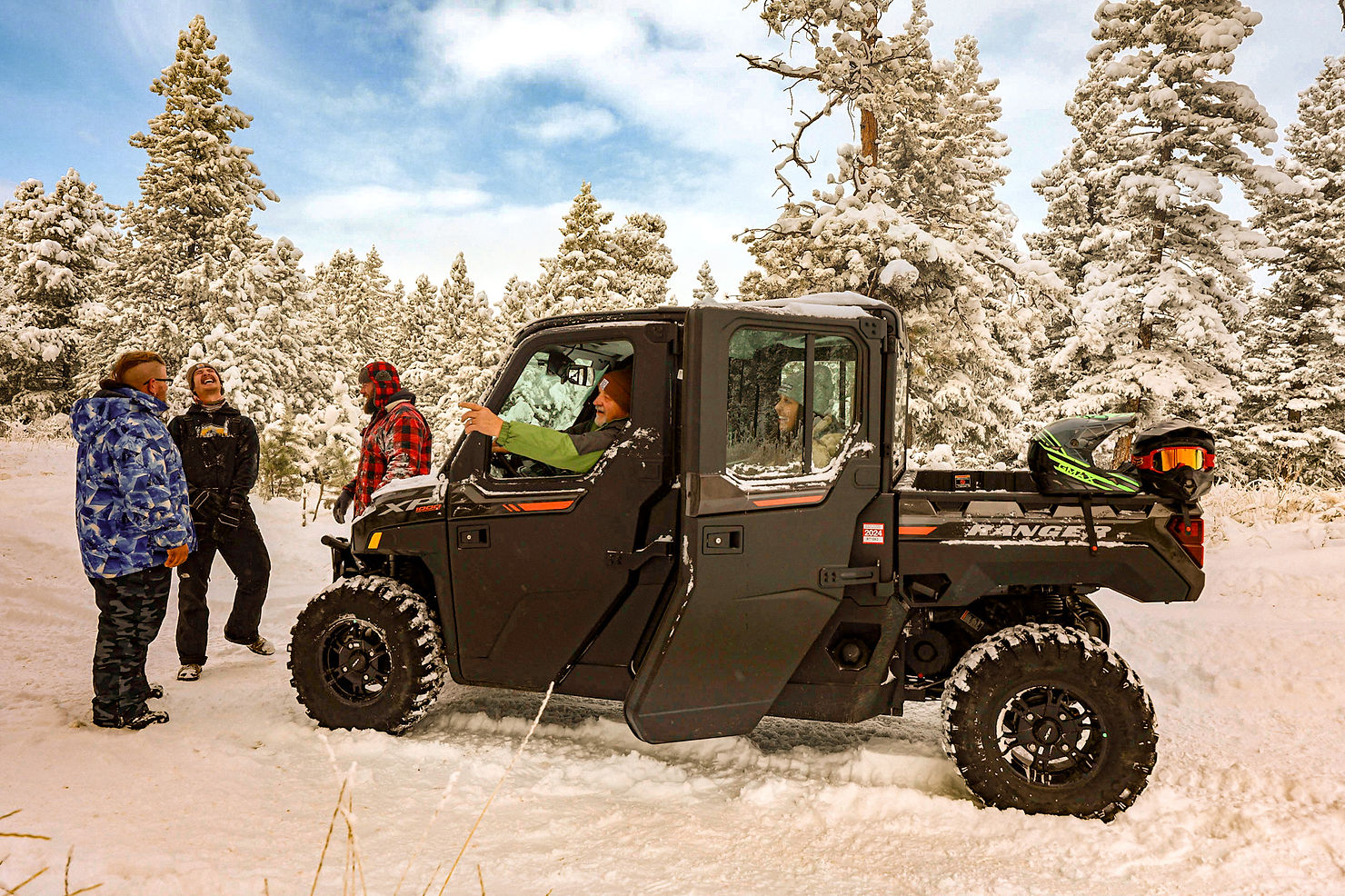 A group of friends enjoy a heated ATV on a snowy day.