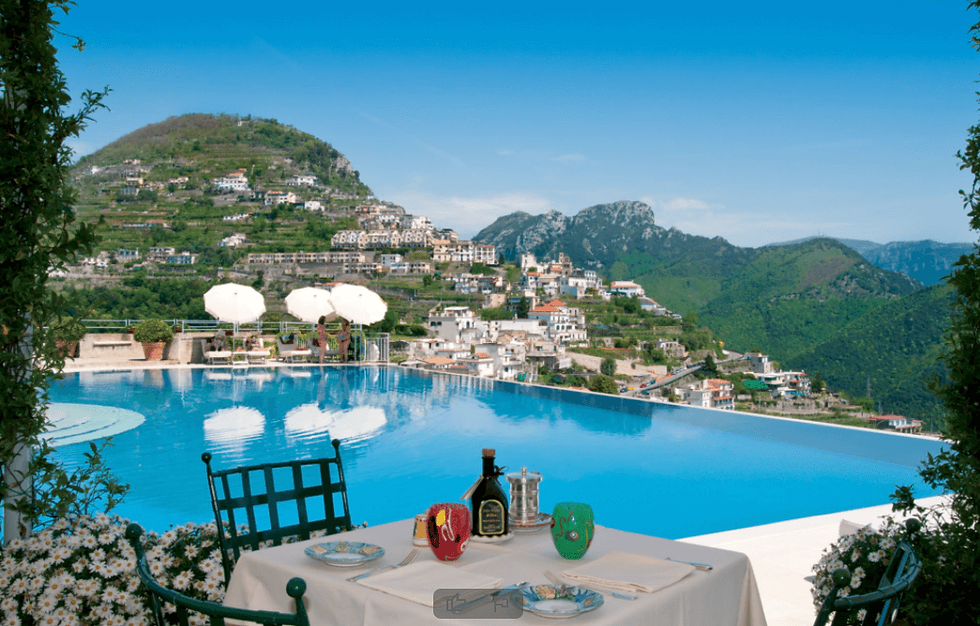 Small table near pool overlooking coast