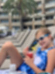 girl in swimsuit and swim goggles with drink