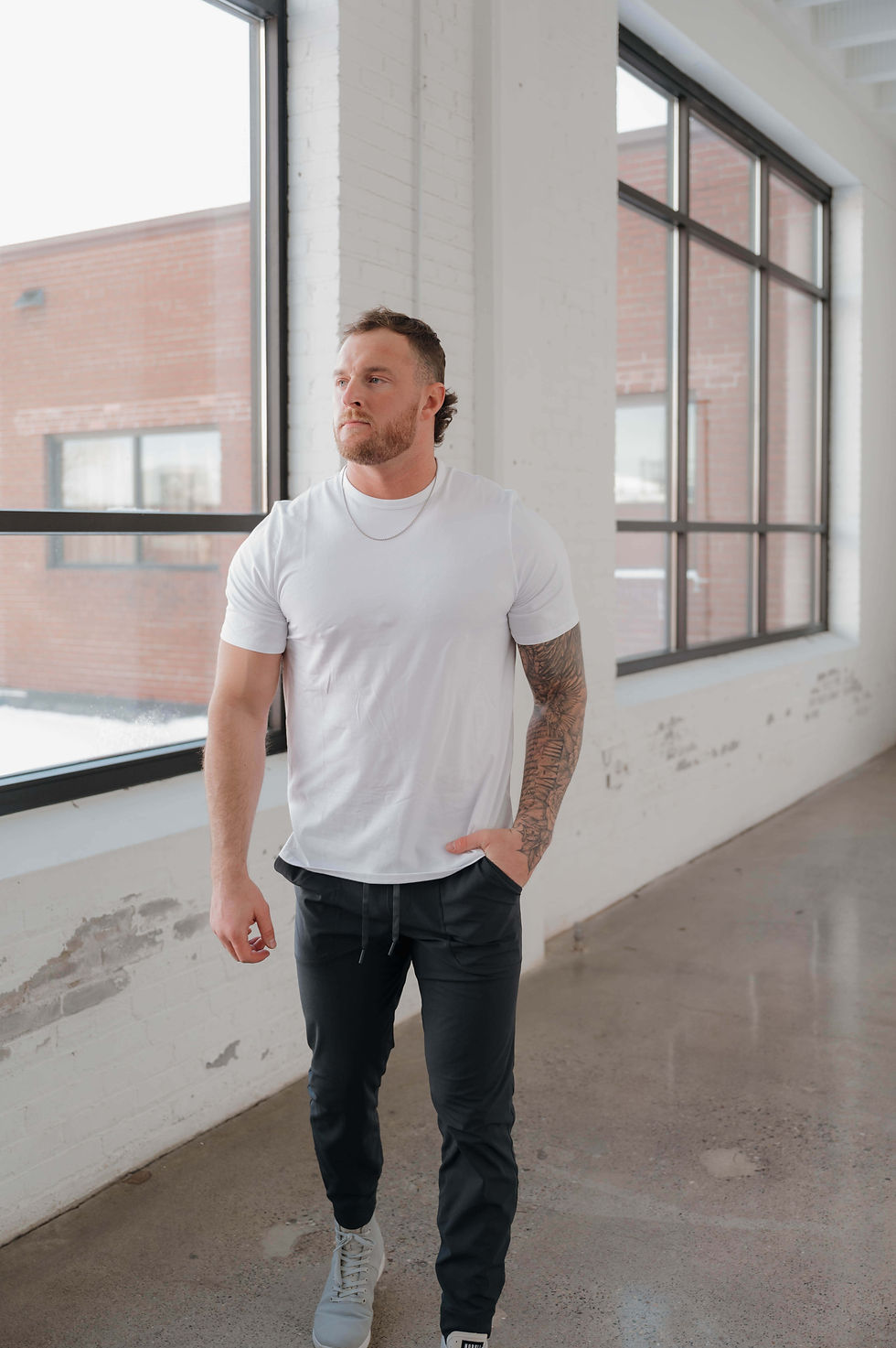 fit man walking with hand in pocket