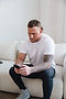 Man with tattoos on phone