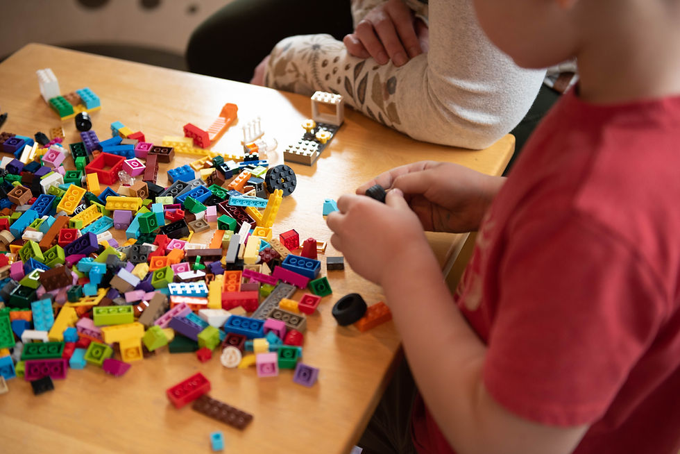 A child playing with a variety of building blocks