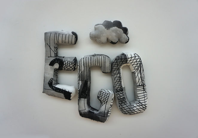 'EGO' soft sculpture with a cloud cushion above, displayed in the gallery front view.