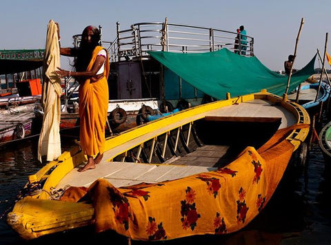 A flood of warm yellows as sarongs are laid out to dry after bathing in the Ganges River #