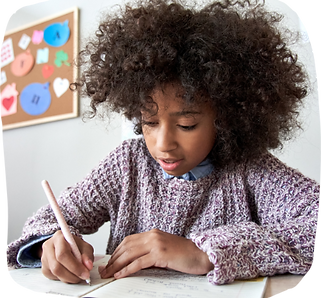 Young child drawing in notebook