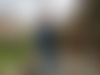 Homeowner inspecting awning on brick house