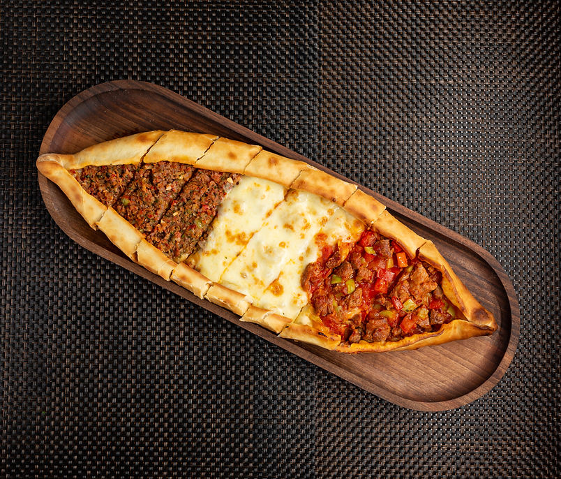 pide-with-stuffed-meat-cheese-pieces-fried-meat-wooden-bowl.jpg