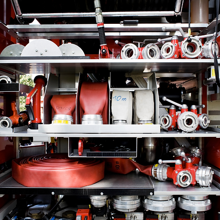 Firefighter eqipement stacked neatly together on shelves.