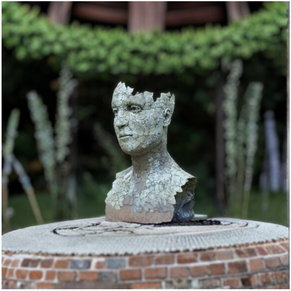 Weathered stone bust with cracked, crumbling surface symbolizing the fragility of the mind