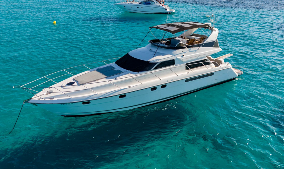 Fairline Squadron 56 Moses luxury yacht charter in Ibiza cruising on turquoise water