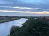 An elevated view of a river with fields and houses either side